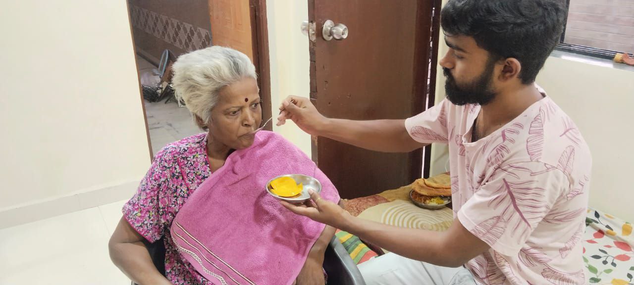 Caregiver feeding nutritious meal to senior resident