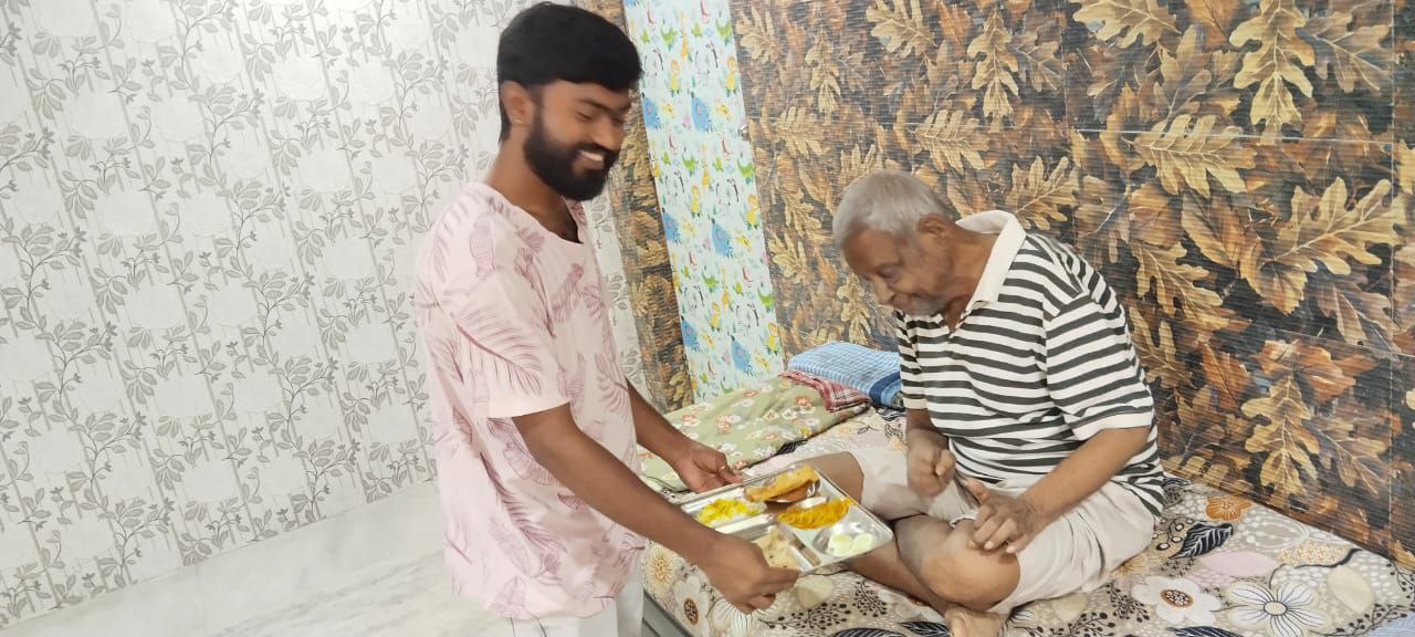 Caregiver serving food to bedridden patient